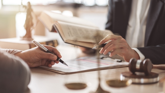 person signing document in law office
